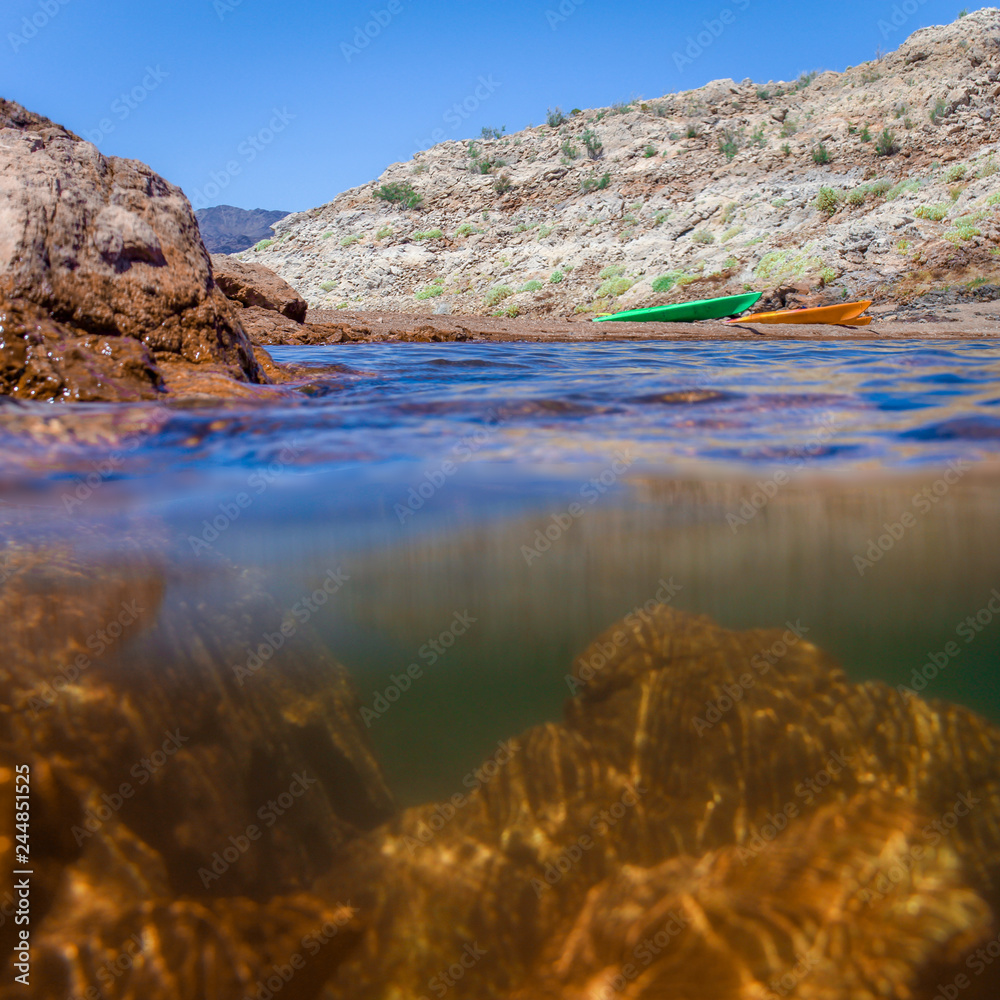 Underwater Split View Photo of a Nevada Lake, with Mountains and a Bright Blue Sky in the Background on a Sunny Day Underwater Split View Photo of a Nevada Lake, with Mountains and a Bright Blue Sky in the Background on a Sunny Day