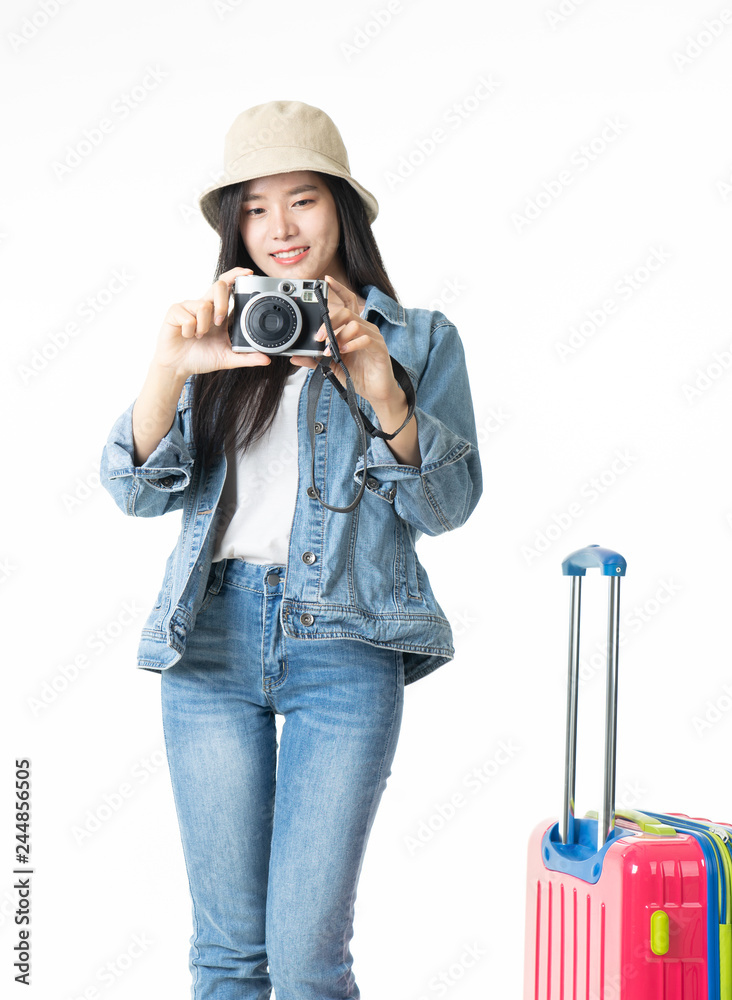 Beautiful young woman smiling and pulling pink color luggage isolated on white background.Asian woman going to summer vacation.Travel trip funny. Beautiful young woman smiling and pulling pink color luggage isolated on white background.Asian woman going to summer vacation.Travel trip funny.