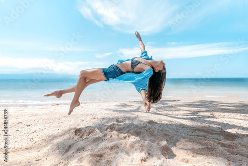 Photos Photograph with the effect of levitation, a young beautiful slim woman hanging i