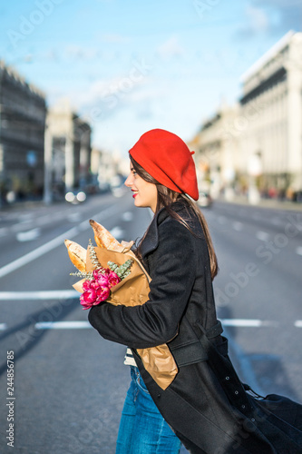 Frenchwoman with baguettes on the street in beret