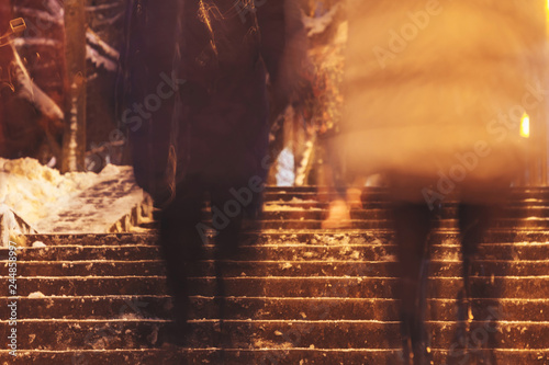 A group of people walk the stairs. Long Exposure. photo