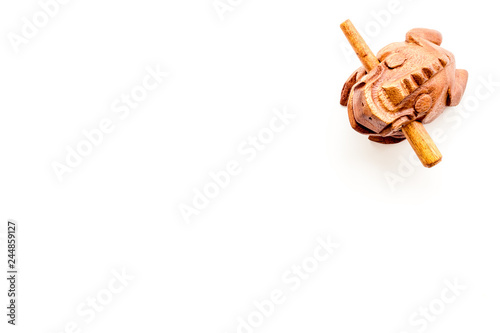 Buddhist symbol. Oriental wooden frog on white background top view copy space