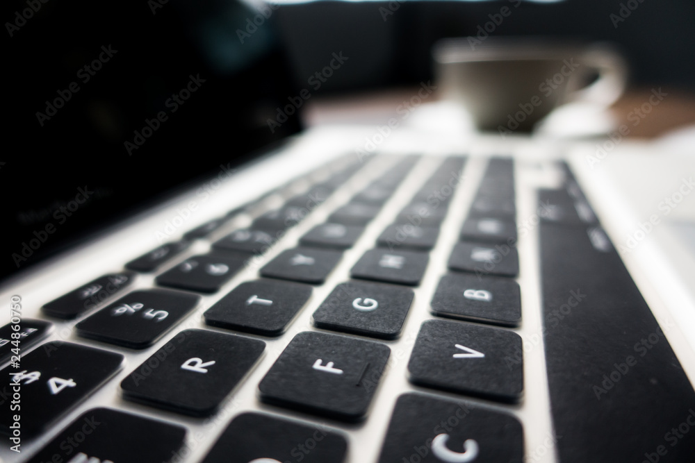 Close up office desk table with laptop, note book, mobile coffee and pen. Selective focus. Business concept. Copy space. Close up office desk table with laptop, note book, mobile coffee and pen. Selective focus. Business concept. Copy space.
