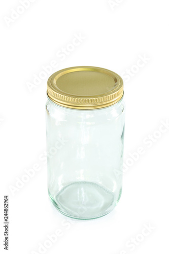 Empty jar of golden cap is closing on a white backgrond.