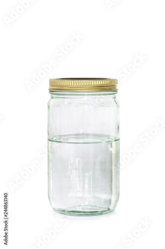 Water into jar of golden cap is closing on a white backgrond.