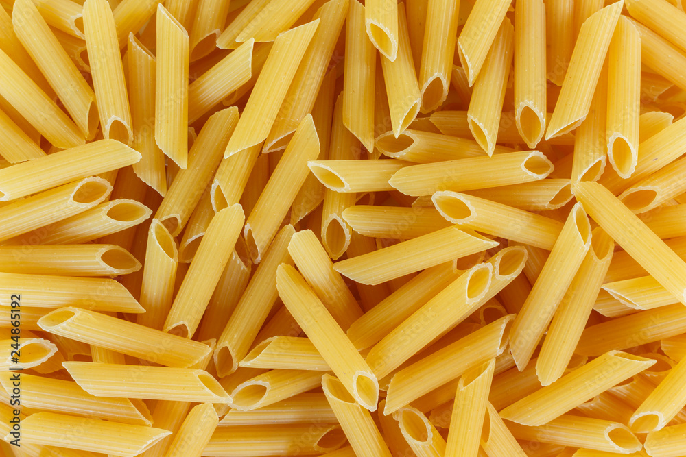 dry pasta penne Italian food texture background. dry pasta penne Italian food texture background.