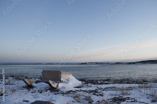 Traditional Inuit cargo sled or Komatik with a box on top and covered in snow, in the Kivalliq style, from Rankin Inlet, Nunavut, Canada