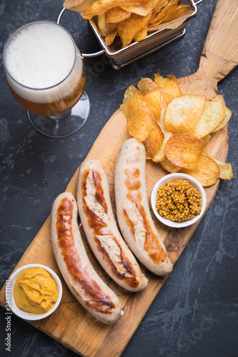 German sausages with mostard and fried potato photo