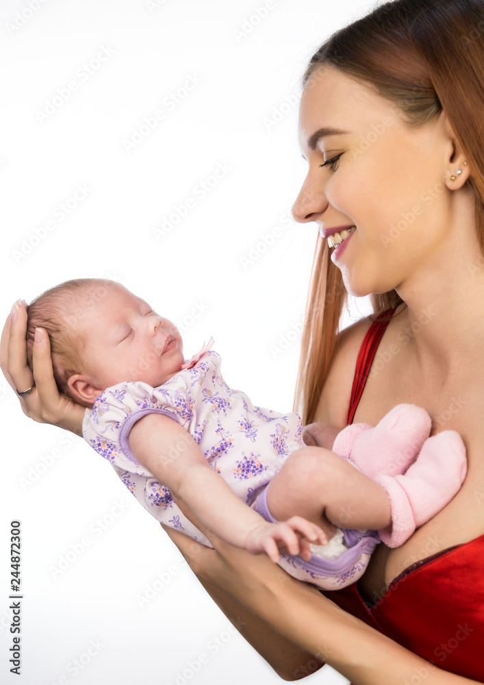 pretty woman kisses and hugging a newborn