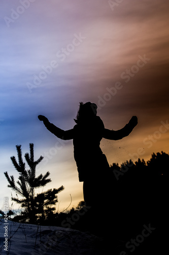 silhouette of a girl jumping in winter