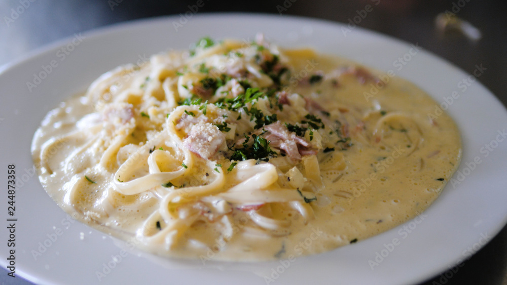 italian food spaghetti carbonara with sauce in a plate italian food spaghetti carbonara with sauce in a plate