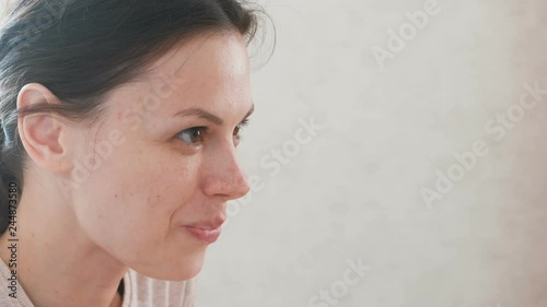 A woman eating something and smiling. Face close-up.