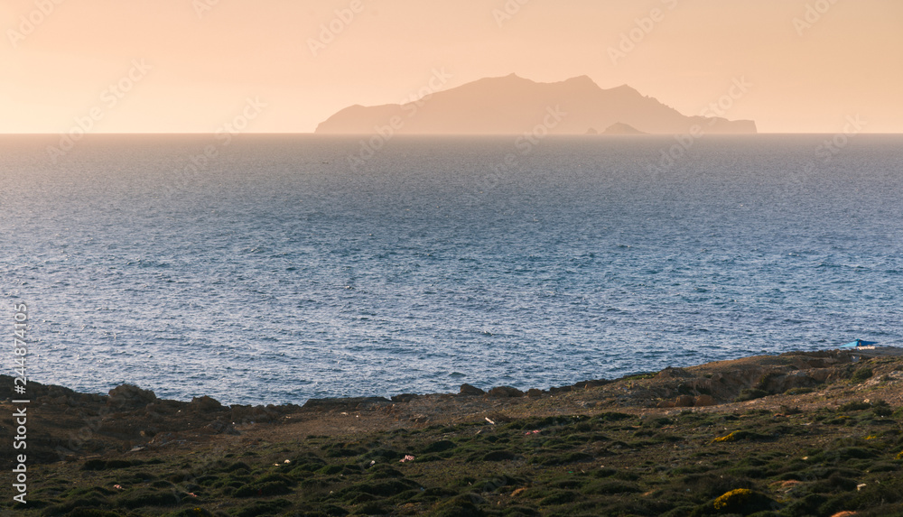 Obraz premium blue ocean with small island in the fog.