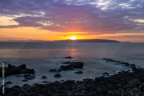 Rocky coast line of the Causeway Coast in Northern Ireland at sunset
