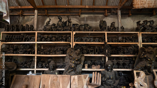 Hindu and Buddhist wooden carving. souvenir shop selling souvenirs and handicrafts of Bali at famous Ubud Market, Indonesia