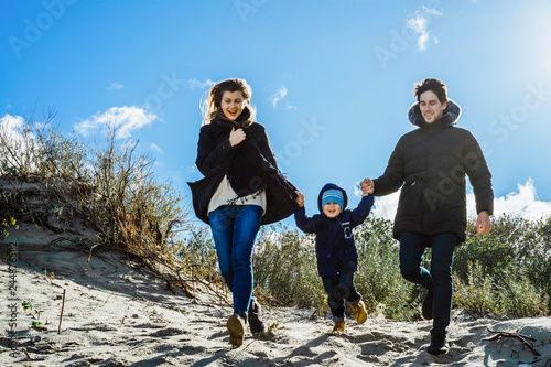 a young family with children spends the weekend on the shores of the cold Baltic sea