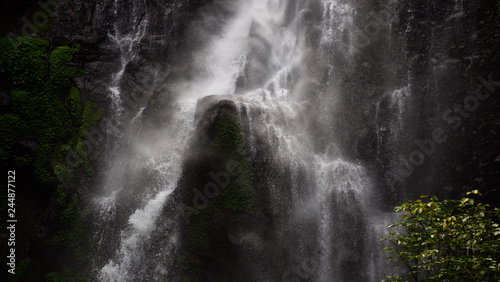 waterfall in green rainforest. triple tropical waterfall Sekumpul in mountain jungle. Bali Indonesia. Travel concept. Aerial footage.