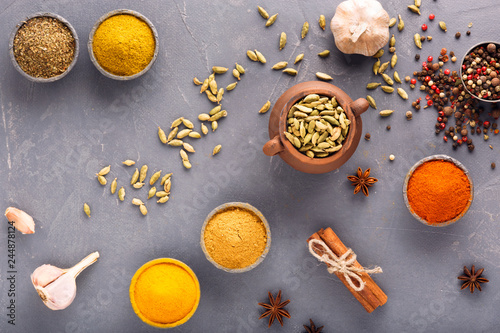 Various colorful spices on wooden table, top view