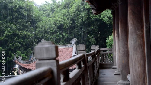 Raining in a buddhist temple in Vietnam from the terrace of the building photo