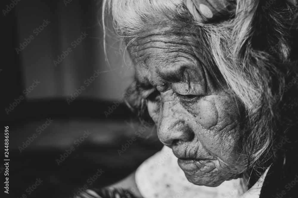 Close-up senior elderly woman. face of sad alone at home, Monochrome filter background Close-up senior elderly woman. face of sad alone at home, Monochrome filter background