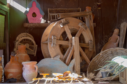 Old small wooden mill wheel, mud containers bird house decor vintage photo