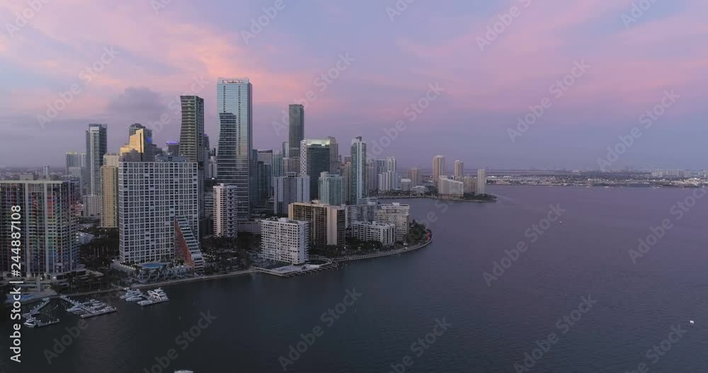 Flying above the ocean along Miami downtown at sunset, Florida Flying above the ocean along Miami downtown at sunset, Florida