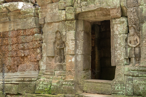 Fototapeta Naklejka Na Ścianę i Meble -  Stone doorway and bas-reliefs at ruined temple
