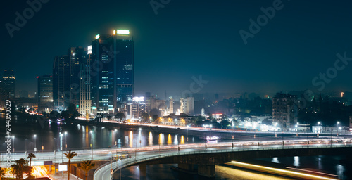 Traffic light trails in Cairo at night, the 15th May bridge, the Nile river and the Corniche Street