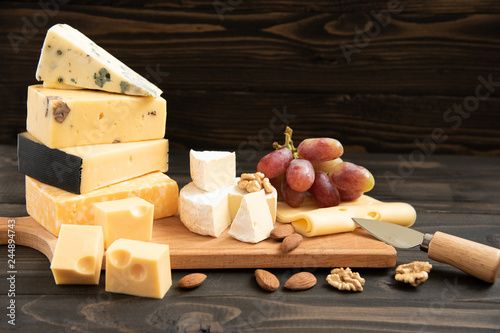 Various types of cheese on a rustic table