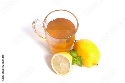 A cup of tea with lemon and mint isolated on white background.