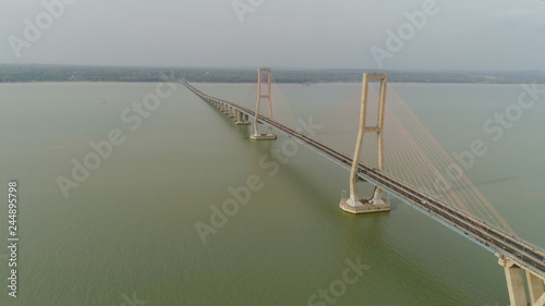 suspension bridge over madura strait with highway and car, surabaya. aerial view bridge Suramadu connecting islands Java and Madura. High coast bridge with highway.java, indonesia © Alex Traveler