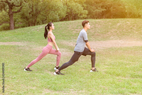 young couple exercising at the city park
