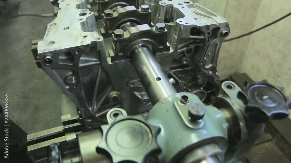 Car engine repair in factory. Engine cylinder head and block repair process