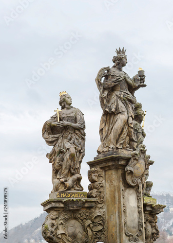 Prague, Czech Republic, Charles bridge. The sculpture "Saints Barbara, Margaret and Elizabeth." Saints Barbara and Margarita are depicted with crowns of martyrs on their heads