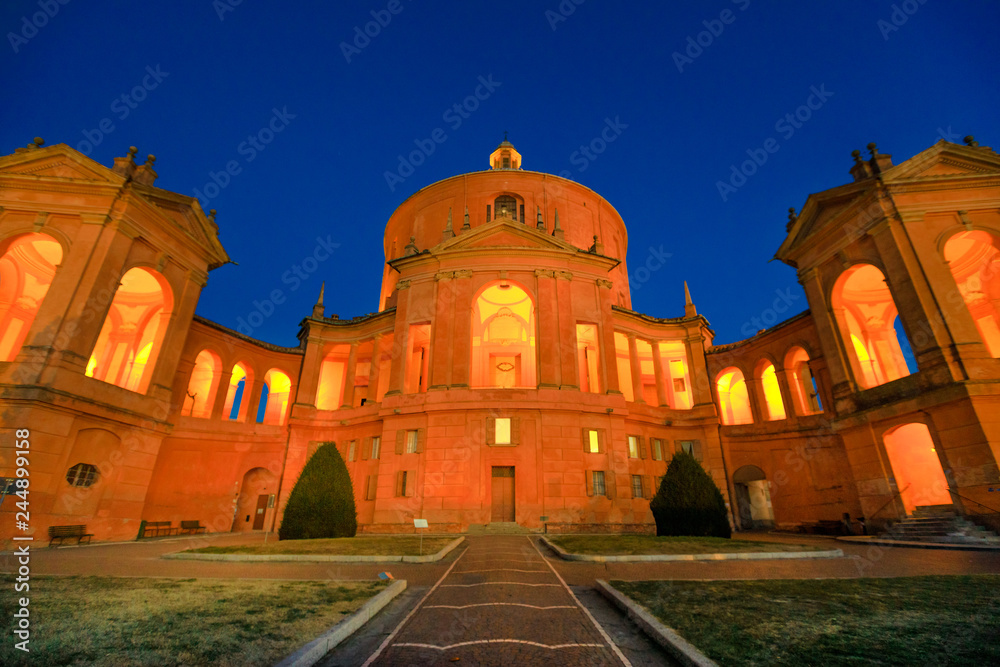 Fototapeta premium Courtyard of Madonna di San Luca Sanctuary illuminated at night. Central facade of Basilica church of San Luca in Bologna, Emilia-Romagna, Italy. Famous landmark cityscape.