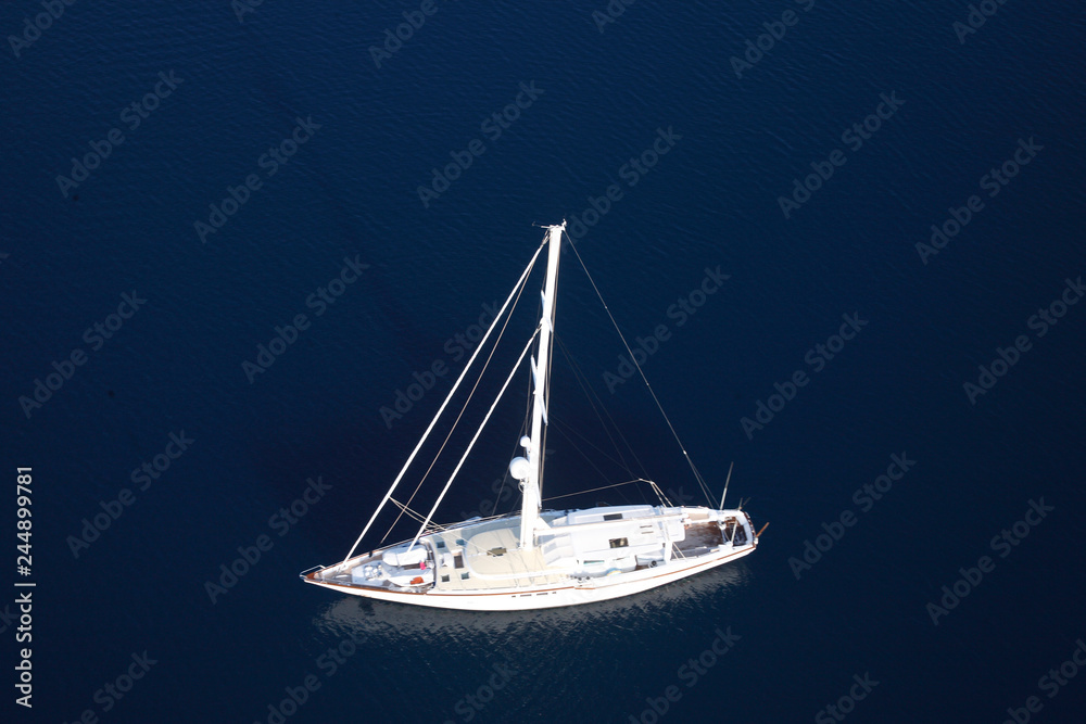 Amazing view to Yacht sailing in open sea at windy day. Drone view - birds eye angle. Yachting theme. Marmaris/Mugla/Turkey. Aegean and Mediterranean sea.