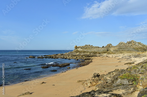 Castro de Barona, Galicia, Spain. Prehistoric settlement ruins and beach with rocks. Blue sea, sunny day.