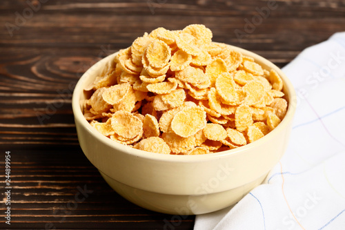 Healthy breakfast. Cornflakes in a bowl on a wooden table. Place for text. Top view.