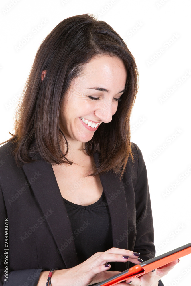 Young smiling woman with tablet by white wall Young smiling woman with tablet by white wall
