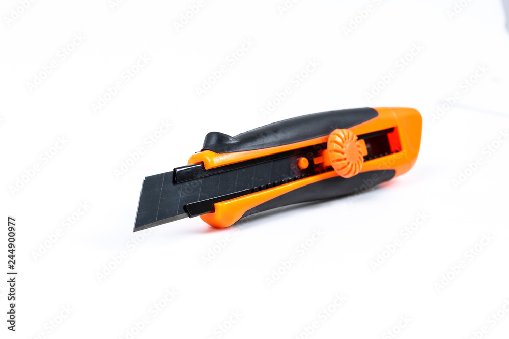 Orange and back paper knife or cutter on white background Orange and back paper knife or cutter on white background