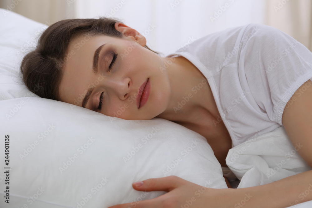 Beautiful young woman sleeping while lying in her bed. Concept of pleasant and rest reinstatement for active life Beautiful young woman sleeping while lying in her bed. Concept of pleasant and rest reinstatement for active life