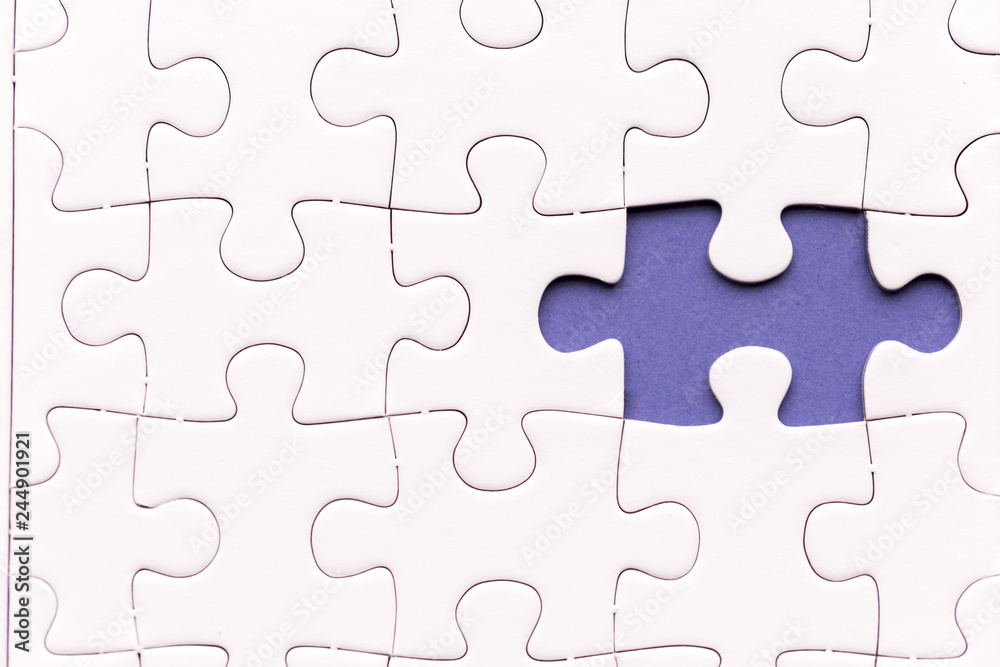 Unfinished white jigsaw puzzle pieces. One missing jigsaw piece on purple background Unfinished white jigsaw puzzle pieces. One missing jigsaw piece on purple background