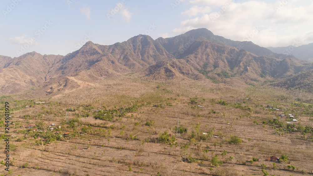aerial view agricultural land and mountains in countryside. mountain range with high cliffs mountain slopes covered with vegetation bali, indonesia