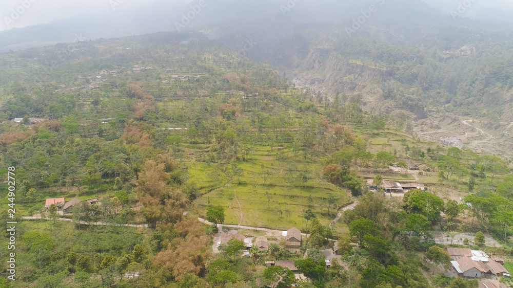 mountain landscape slopes mountains covered with green tropical forest. Jawa, Indonesia. aerial view mountain forest with large trees and green grass. mountain landscape slopes mountains covered with green tropical forest. Jawa, Indonesia. aerial view mountain forest with large trees and green grass.