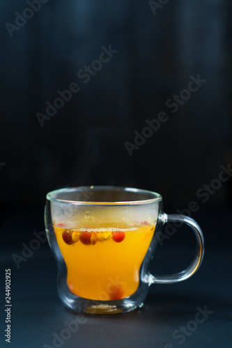 sea buckthorn tea in cups on black background