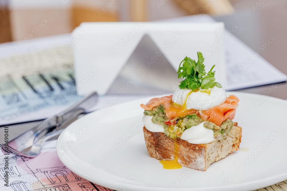 Toast with guacamole, salmon and poached egg. Toast with guacamole, salmon and poached egg.