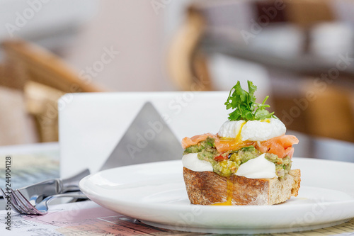 Toast with guacamole, salmon and poached egg.