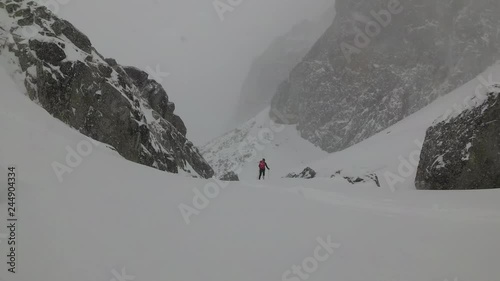 Snow Storm in the Mountains a Tourist With a Backpack Travels in the Mountain photo