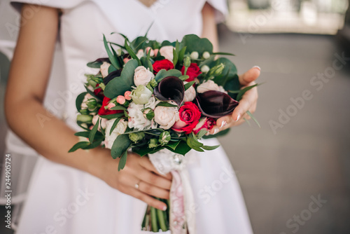 Fototapeta Naklejka Na Ścianę i Meble -  beautiful bouquet of flowers in the tender hands of a young bride