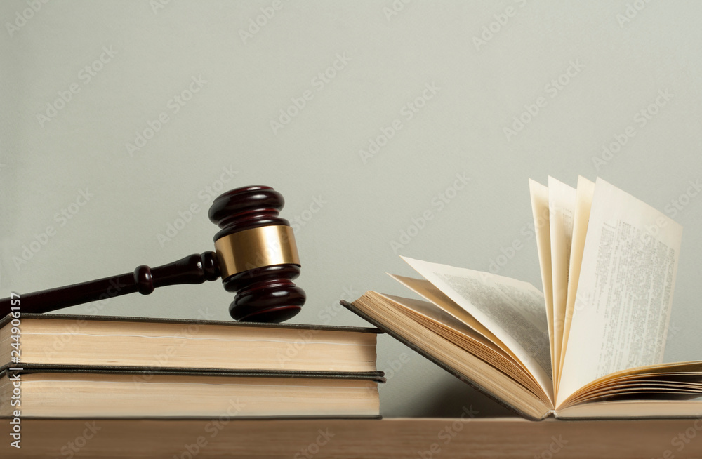 Law concept. Wooden judge gavel with law books on table in a courtroom or enforcement office. Law concept. Wooden judge gavel with law books on table in a courtroom or enforcement office.